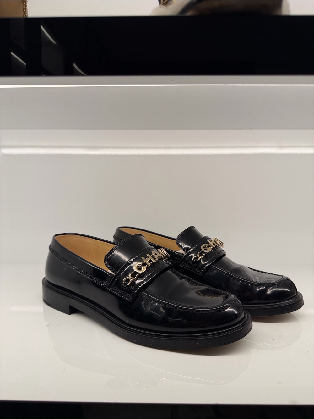 CHANEL Black Patent Leather Loafers with Gold Chain Logo
